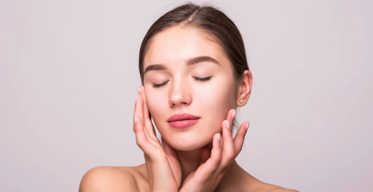 A woman with her hands on her face, expressing surprise or contemplation.