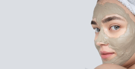 A woman wearing a face mask, looking directly at the camera with a neutral expression.