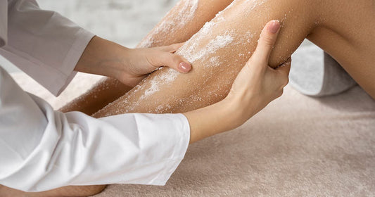 A woman applying scrub, demonstrating a step in the process of exfoliating for smooth skin.